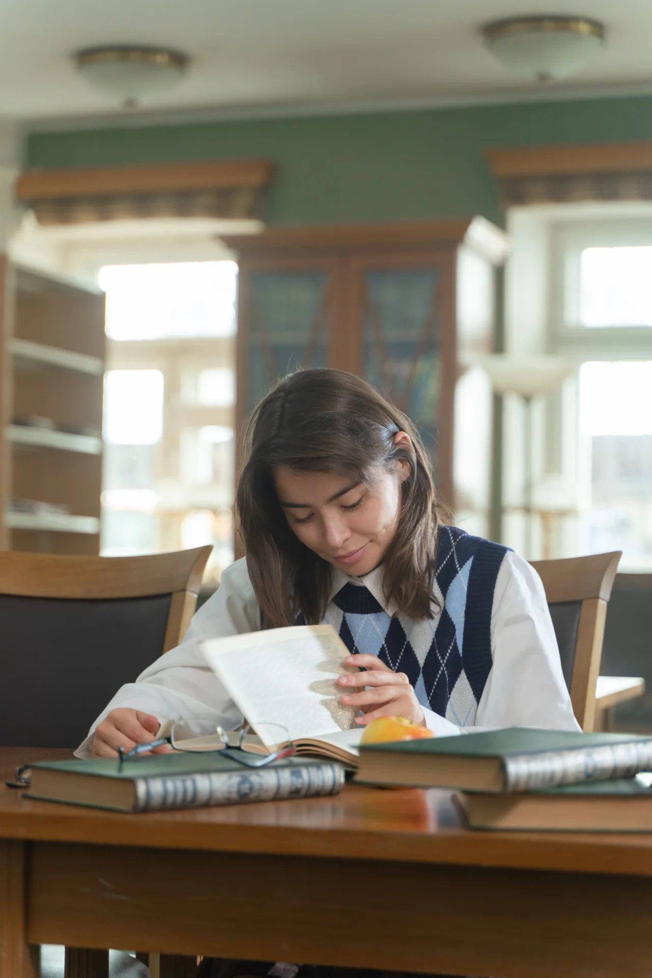 A student reading and making notes in a school library