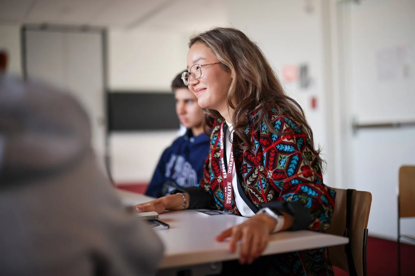 A mentor listening to students during a learning session
