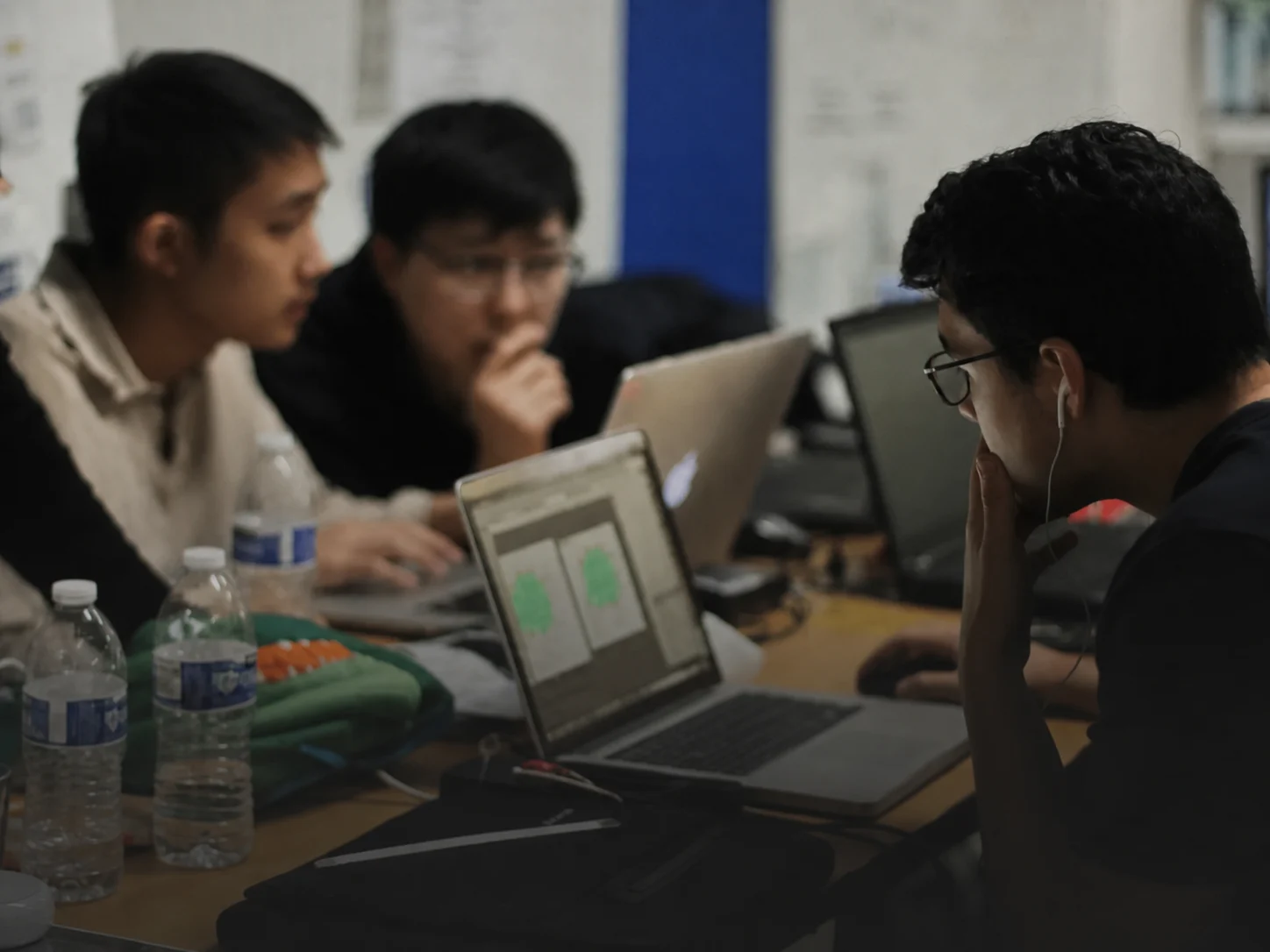 Pitch Competition Prep students collaborating around a laptop